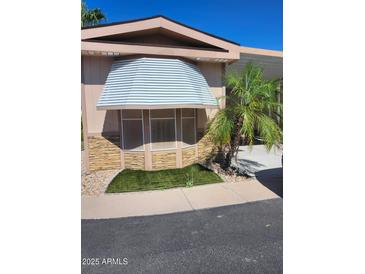 Charming home featuring stone accents, awning, and a well-maintained landscape at 2929 E Main St # 601, Mesa, AZ 85213