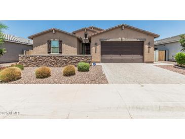 Charming single-story home features a stone accent wall, desert landscaping, and a two-car garage at 3948 E Caitlin Dr, San Tan Valley, AZ 85140
