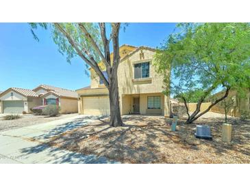 Charming two-story home featuring a well-manicured front yard and a two-car garage at 10524 W Pima St, Tolleson, AZ 85353