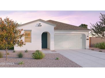 Charming single-story home with a two-car garage, stucco finish, and desert landscaping at 12561 W Trumbull Rd, Avondale, AZ 85323