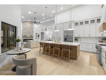 Bright open-concept kitchen features a large island, breakfast bar, stainless appliances, and pendant lighting at 12638 E Cortez Dr, Scottsdale, AZ 85259