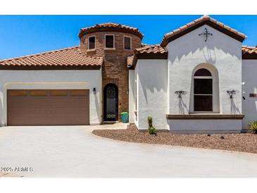 Charming single-story home featuring a tile roof, stucco exterior, and a two-car garage at 1809 E Gwen St, Phoenix, AZ 85042