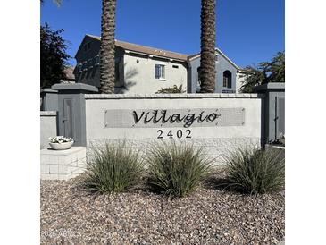 Community sign with address and view of buildings and palm trees in the Villagio neighborhood at 2402 E 5Th St # 1457, Tempe, AZ 85288