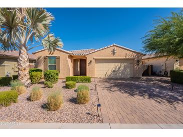 Inviting single-story home featuring a well-manicured front yard with desert landscaping and a charming covered entryway at 2680 E Daniel Dr, Gilbert, AZ 85298
