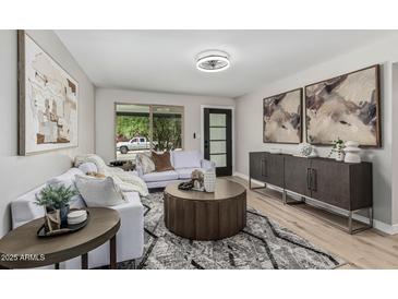 Bright living room with stylish furnishings, modern decor, and a large window at 4416 E Capistrano Ave, Phoenix, AZ 85044