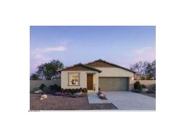 Charming single-story home showcasing desert landscaping and a two-car garage in a peaceful community at 5657 S 253Rd Ave, Buckeye, AZ 85326
