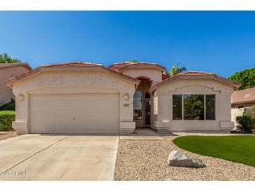 Charming single-story home featuring stucco siding, a two-car garage, and manicured desert landscaping at 6502 W Wahalla Ln, Glendale, AZ 85308