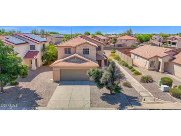Two-story home with neutral stucco, tile roof, desert landscaping, and a two car garage at 885 E Lakeview Dr, San Tan Valley, AZ 85143
