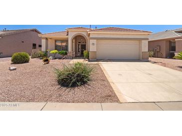 Inviting single-Gathering home featuring desert landscaping, arched entryway, and two-car garage at 17805 W Arizona Dr, Surprise, AZ 85374