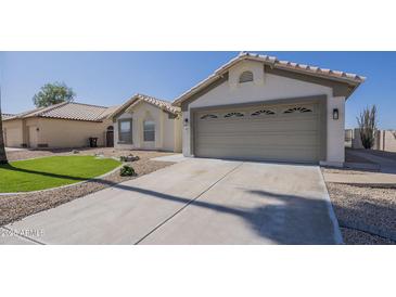 Charming single-story home with a well-manicured lawn, two car garage, and desert landscaping at 6029 E Palm St, Mesa, AZ 85215