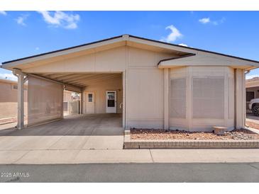 Inviting home exterior with a covered parking and desert landscaping showcasing the charming facade at 6461 S Oakmont Dr, Chandler, AZ 85249