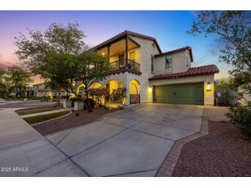 Charming home featuring a 2-car garage, balcony, and a well-manicured lawn at 20518 W White Rock Rd, Buckeye, AZ 85396