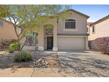 Inviting two-story home featuring a two-car garage and low maintenance desert landscaping at 2511 W Blue Sky Dr, Phoenix, AZ 85085
