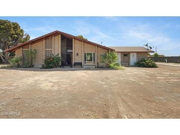 Charming brick home featuring a peaked roof, desert landscaping, and welcoming front entrance at 2921 N 103Rd Ave, Avondale, AZ 85392