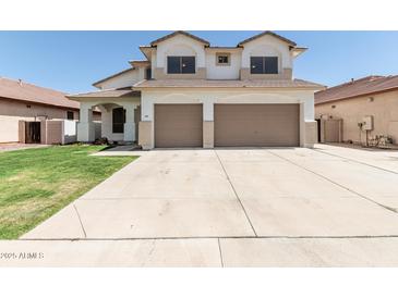 Two-story home features a two-car garage, green lawn, and desert landscaping at 3851 E San Pedro Ave, Gilbert, AZ 85234