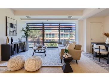 Bright living room with large window, modern furnishings, and neutral color palette at 7151 E Rancho Vista Dr # 6002, Scottsdale, AZ 85251