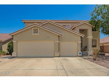 Charming two-story home with a three car garage and desert landscaping at 7923 W Hess Ave, Phoenix, AZ 85043