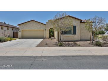 Charming single-story home with a two-car garage, desert landscaping, and an inviting front entrance at 17082 S 182Nd Ave, Goodyear, AZ 85338