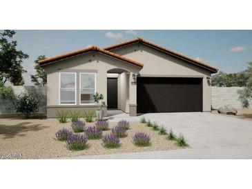 Charming single-story home featuring a desert-landscaped front yard and an attached two-car garage at 17962 W Sand Hills Rd, Surprise, AZ 85387