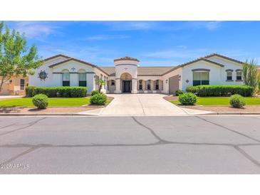 Stunning home showcasing a circular entryway, manicured landscaping, and a spacious driveway at 20115 E Sonoqui E Blvd, Queen Creek, AZ 85142