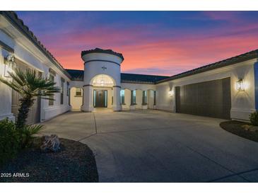 Stunning home exterior with a turret entrance, large driveway, and manicured landscaping at 20115 E Sonoqui E Blvd, Queen Creek, AZ 85142