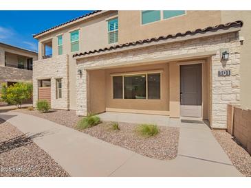 Charming townhome featuring a stone facade, covered entryway, and well-maintained desert landscaping at 4562 S Park Grove St # 101, Gilbert, AZ 85297