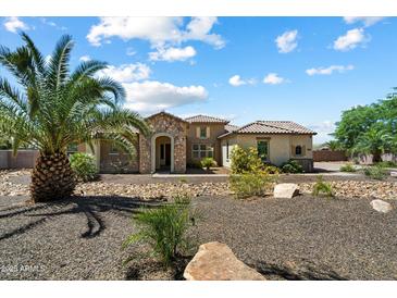 Stunning single-Gathering home with stone accents, desert landscaping, and a well-manicured front yard at 7205 W Fallen Leaf Ln, Peoria, AZ 85383