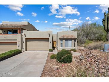 Charming single-level home with a desert-style front yard and two car garage at 12642 N Mountainside Dr # D, Fountain Hills, AZ 85268
