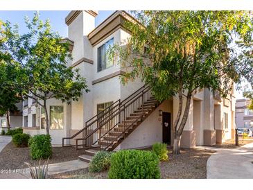 Charming condo featuring tan exterior, stairway to the front door, and mature landscaping at 1941 S Pierpont Dr # 1037, Mesa, AZ 85206