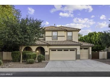 Inviting two-story home featuring a tile roof, multiple car garage, and well-maintained landscaping at 1953 E Lafayette Ave, Gilbert, AZ 85298