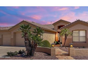 Inviting single-story home boasting desert landscaping, walkway, and warm exterior lighting at 2069 E Winchester Way, Chandler, AZ 85286
