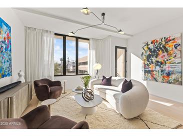 Bright living room featuring modern lighting, plush seating, and floor-to-ceiling windows at 312 E Windsor Ave # 6, Phoenix, AZ 85004