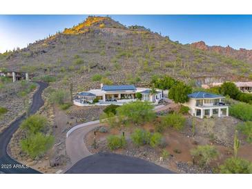 Expansive desert home featuring multiple buildings with modern architecture and lush landscaping at 6432 E El Sendero Rd, Carefree, AZ 85377