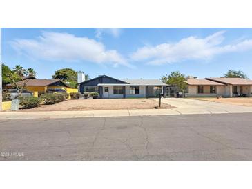 Charming single-story home featuring a cozy front yard and a classic suburban street view at 7730 W Mulberry Dr, Phoenix, AZ 85033