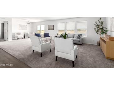 Spacious living room featuring neutral tones, plush carpet, and bright natural light from large windows at 10284 E Shallow Canyon Rd, San Tan Valley, AZ 85143