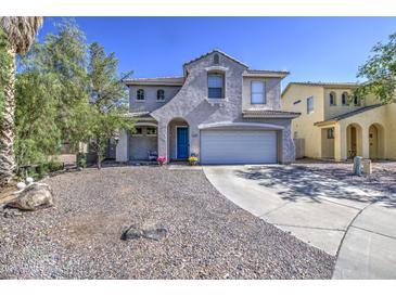 Two-story home with a well-manicured front yard and a blue front door at 1107 E La Salle St, Phoenix, AZ 85040
