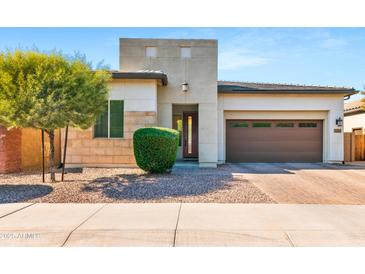 Inviting exterior featuring desert landscaping, a modern design and a two-car garage for easy parking at 1492 W Bruce Ave, Gilbert, AZ 85233