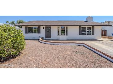 Charming single-story home featuring a well-maintained front yard and a decorative wreath on the front door at 2337 E Contessa St, Mesa, AZ 85213