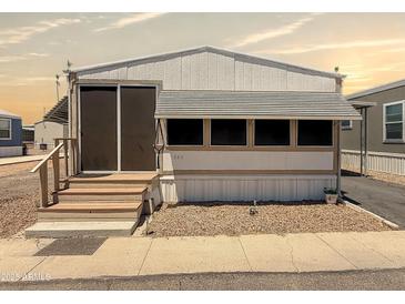 Charming single-story home featuring a covered entry and neatly maintained gravel landscaping at 2701 E Allred Ave # 171, Mesa, AZ 85204