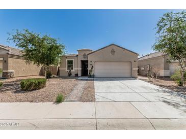 Charming single-story home featuring a two-car garage and low maintenance desert landscaping at 3112 N 303Rd Dr, Buckeye, AZ 85396