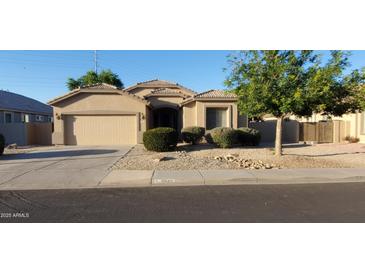 Beautiful one-story home featuring a two-car garage and desert landscaping at 3247 E Lark Ct, Gilbert, AZ 85297