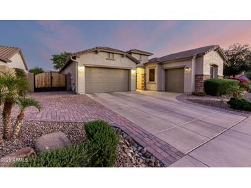 Charming home with three-car garage, stone accents, and well-manicured landscaping at 5607 W Alyssa Ln, Phoenix, AZ 85083