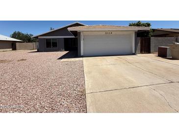 Charming single-story home features a two-car garage and low-maintenance desert landscaping at 5634 W Puget Ave, Glendale, AZ 85302