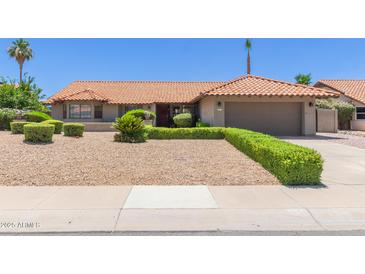 Inviting single-story home with a low-maintenance desert landscape and charming orange tile roof at 6017 E Kathleen Rd, Scottsdale, AZ 85254