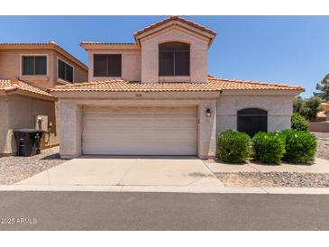 Charming home with a tile roof, attached garage, and well-maintained landscaping in a residential neighborhood at 7621 S Bonarden Ln, Tempe, AZ 85284