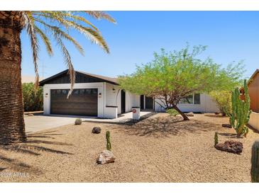 Charming single-story home with a well-kept yard, desert landscaping, and a two-car garage at 811 E Brown St, Phoenix, AZ 85020