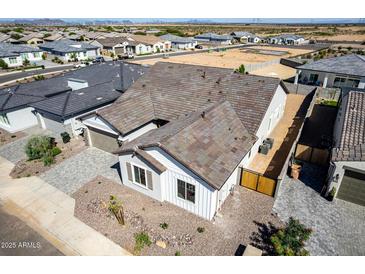 Aerial view of a charming home with a well-maintained front yard and neutral color palette at 13619 W Hackamore Dr, Peoria, AZ 85383