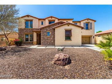 Beautiful two-story home featuring a low maintenance desert rock front yard and a charming desert landscape at 19415 W Colter St, Litchfield Park, AZ 85340