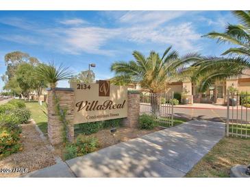 Inviting Villa Real Condominium Homes sign with lush landscaping and clear blue sky at 2134 E Broadway Rd # 2031, Tempe, AZ 85282
