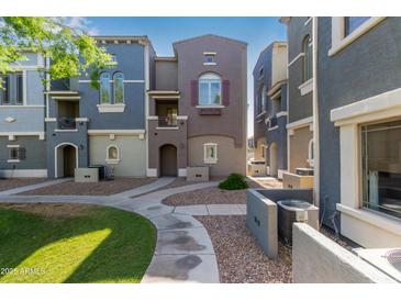 View of townhome exteriors with landscaped walkways, various color schemes and charming architectural details at 2401 E Rio Salado Pkwy # 1048, Tempe, AZ 85288